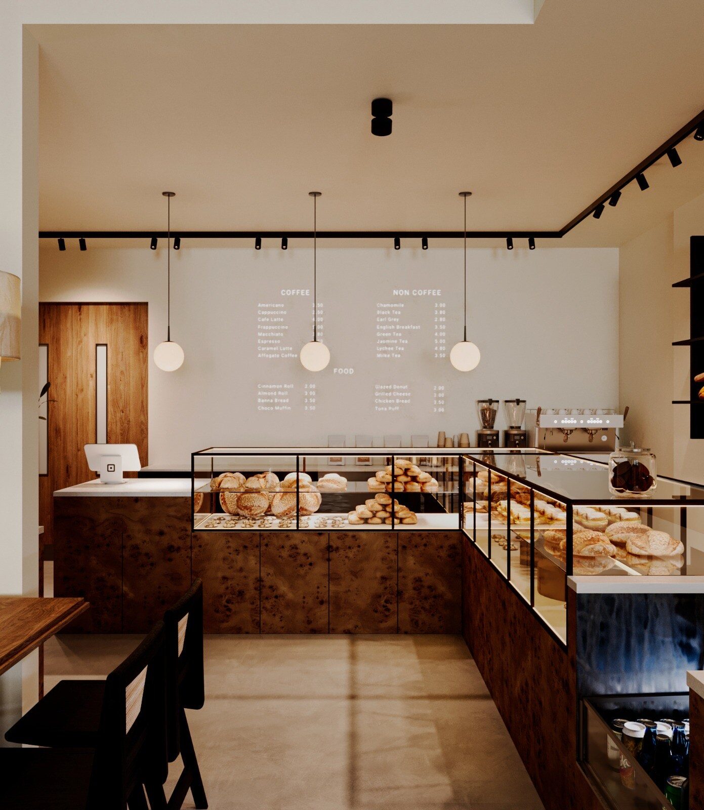 The bakery counter in burl wood beneath the hand-lettered coffee menu — globe pendants, a glass vitrine of fresh bread and pastry, and the espresso station beyond