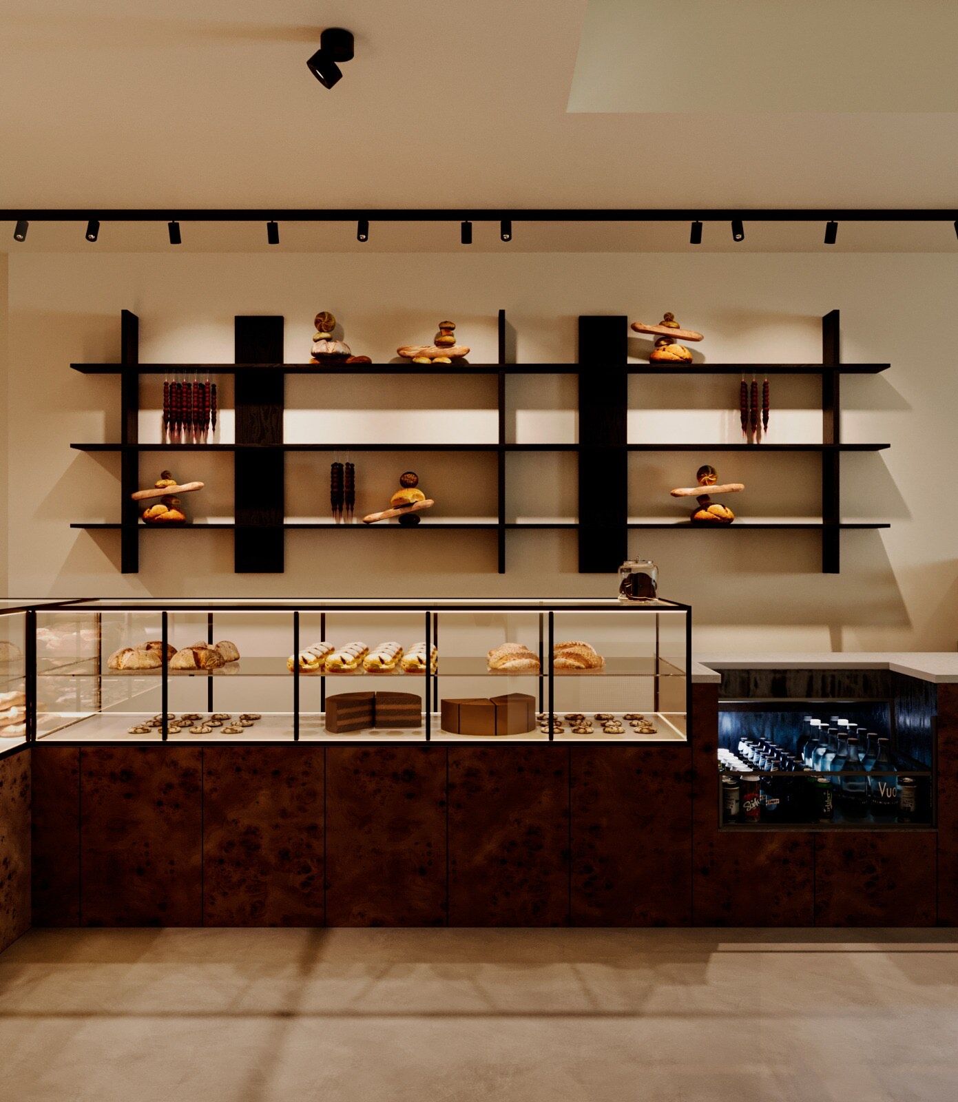 The bakery counter — a burl-wood base, a pastry vitrine, and black steel shelves lined with fresh bread
