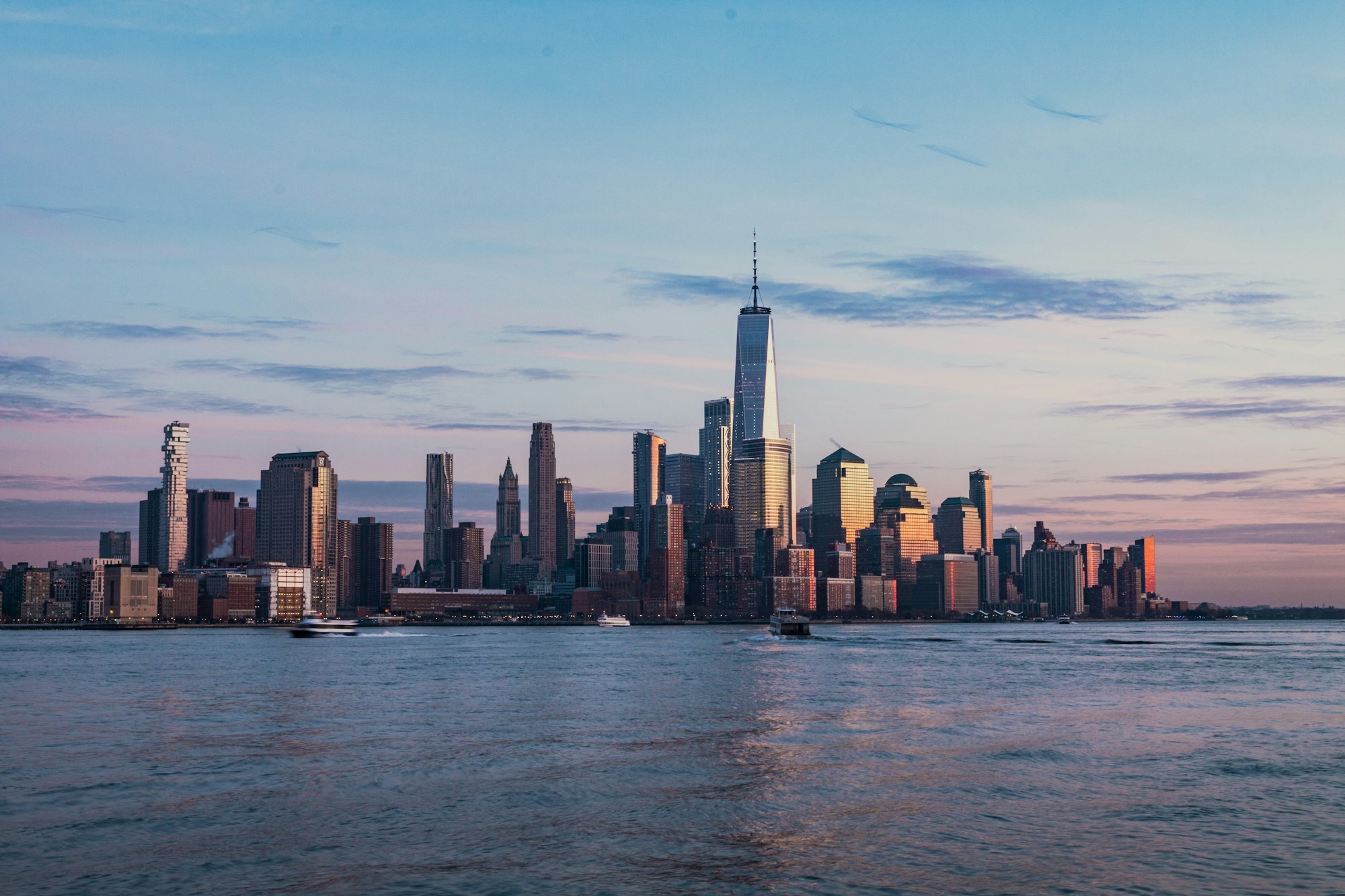 Lower Manhattan skyline at dusk, seen across the water