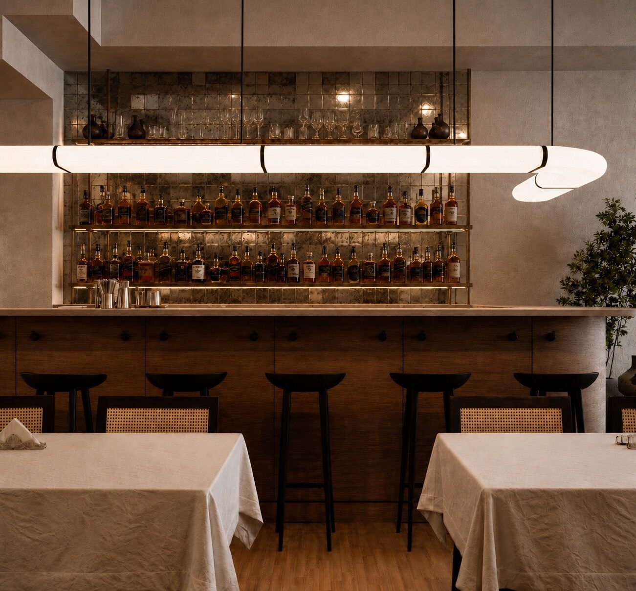 Linear pendant over the bar and backlit bottle shelving at Sesilya in Park Slope, designed by ORÉA COLLECTIVE