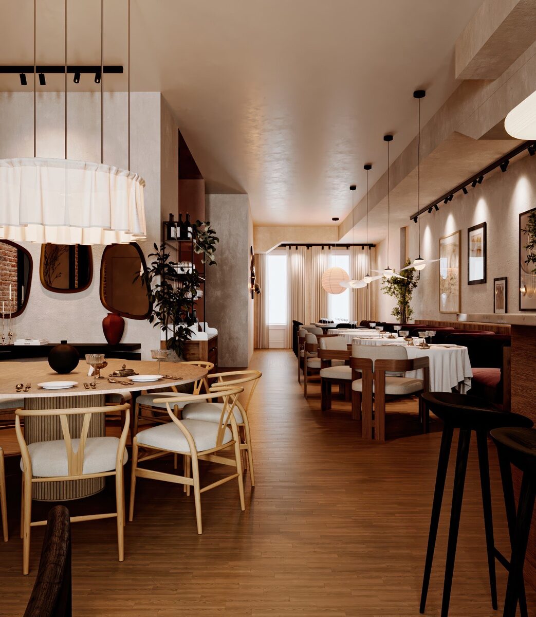 The dining room under paper lantern pendants, a bronze horn sconce on the plaster wall