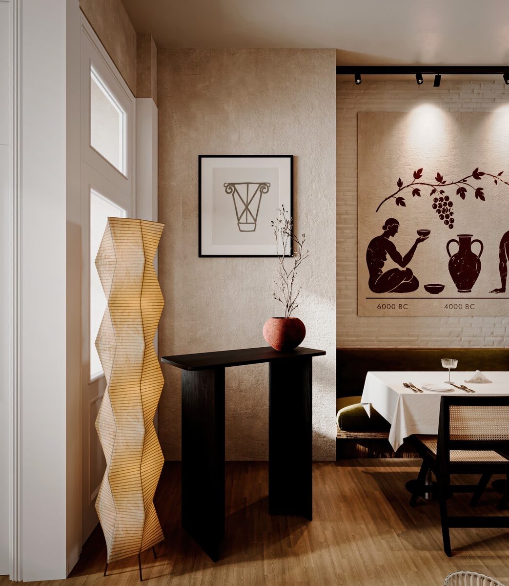 The entry vestibule — a sculptural pleated floor light, a black console, and the vine mural beyond
