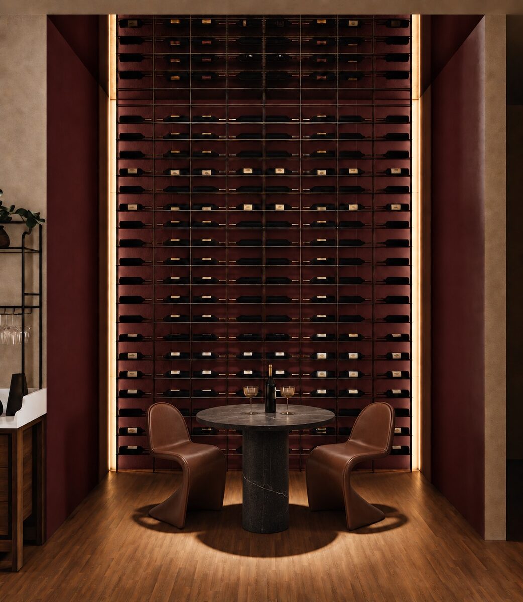 The full-height wine wall lit from within, a small round table set into the alcove