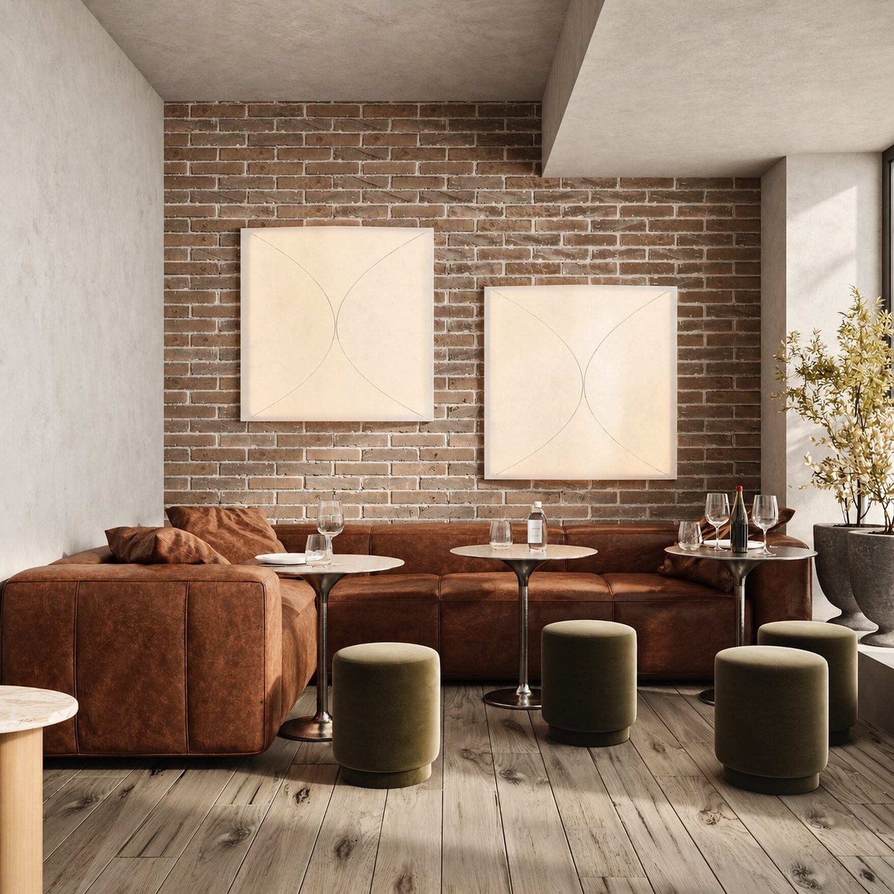 Leather banquette, velvet poufs and two framed artworks against exposed brick at Lab148 in Williamsburg